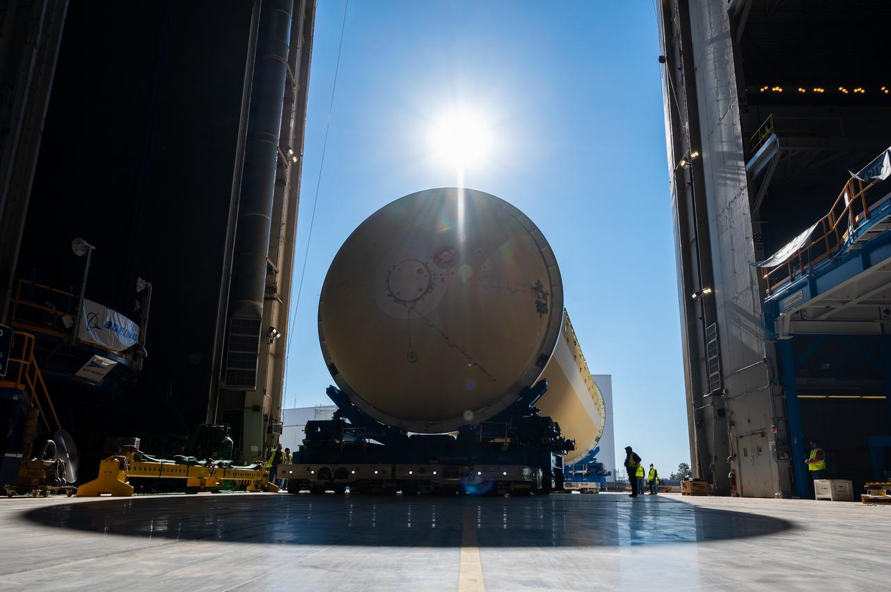 Technicians transported the assembled upper part of the Artemis II core stage to the final assembly area inside the factory at NASA’s Michoud Assembly Facility in New Orleans. On Jan 10, the forward assembly, left was moved next to the Artemis II liquid hydrogen tank, which has been undergoing assembly. Next, Boeing, the lead core stage contractor, will join the forward assembly and the liquid hydrogen tank to complete most of the core stage for the Space Launch System (SLS) rocket that will send the first crew on an Artemis mission. The core stage consists of five major structures that are built, outfitted, and then connected to form the final stage. The forward skirt, liquid oxygen and intertank were connected and tested to form the 66-foot forward assembly. After the forward assembly is joined with the 130-foot liquid hydrogen tank, only the engine section, the fifth piece of the stage, will need to be added to complete the Artemis II core stage. The core stage serves as the backbone of the rocket, supporting the weight of the payload, upper stage, and crew vehicle, as well as the thrust of its four RS-25 engines and two five-segment solid rocket boosters attached to the engine and intertank sections. On Artemis II, the SLS rocket will launch the Orion spacecraft and a crew, sending them into lunar orbit, in preparation for later Artemis missions that will enable the first woman and first person of color to land on the Moon.
